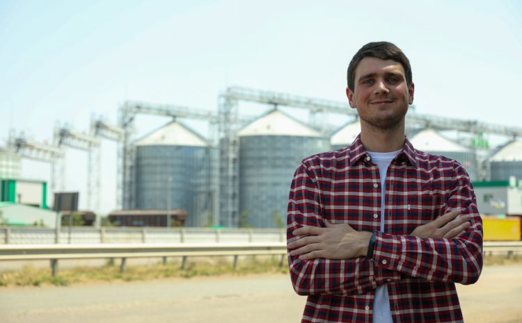 young man against grain silos agriculture business Copiar
