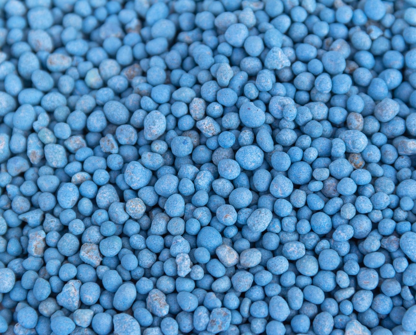 blue different shape chemical fertilizer granules as abstract background Copiar 2